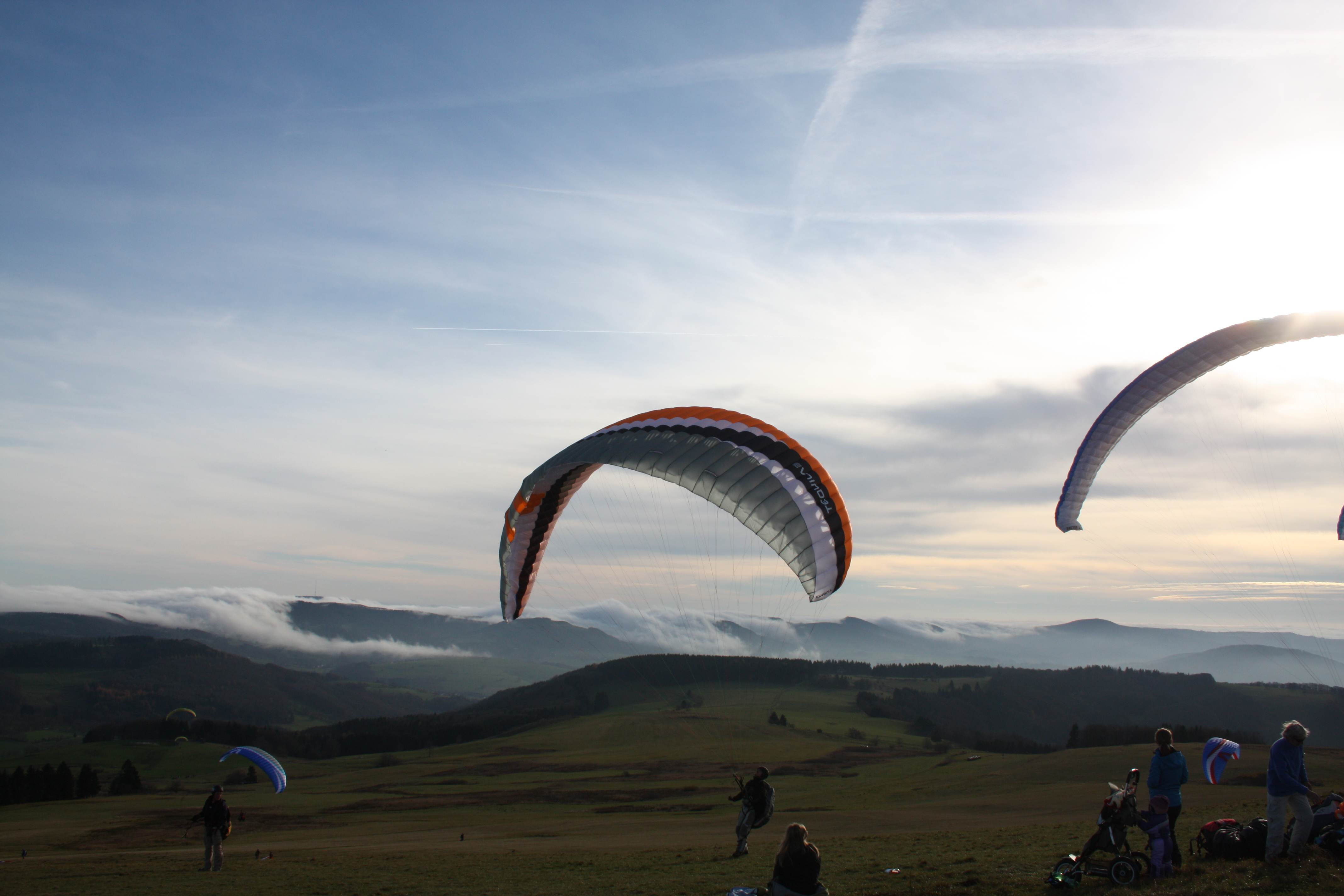 Paraglider mit dem Ausblick von der Wasserkuppe in das Biosphärenreservat Rhön.
